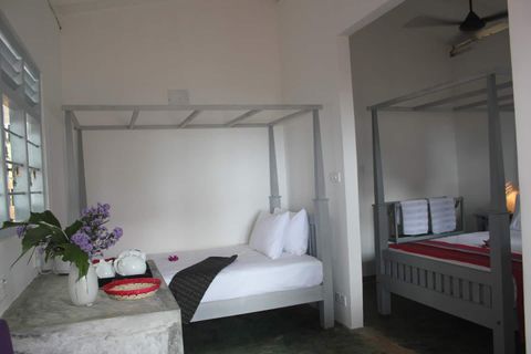Room Three at EKA Beach with a queen bed and a double bed under mosquito canopies