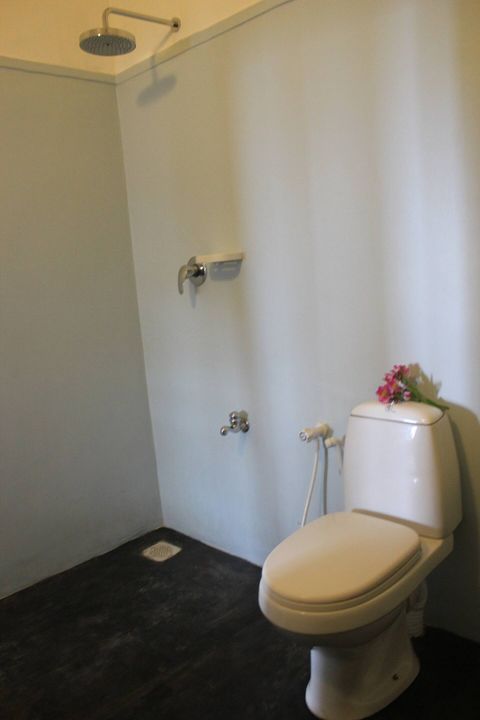 A walk-in shower in a private en-suite bathroom at EKA Beach