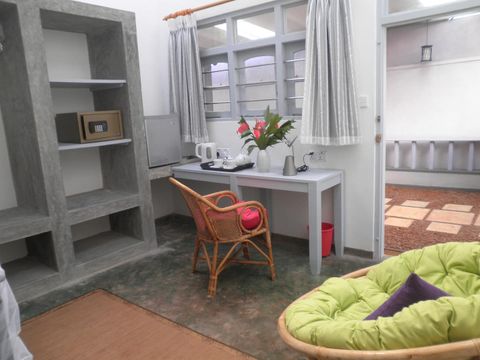 A desk and chair set up as a workspace in a room at EKA Beach