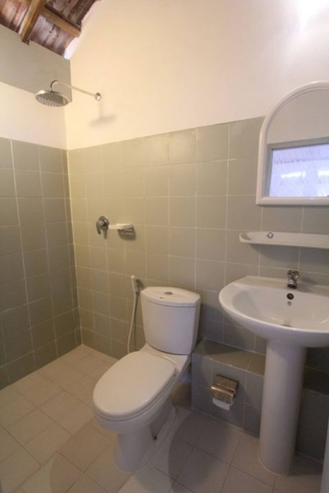 A private tiled en-suite bathroom in a room at EKA Beach